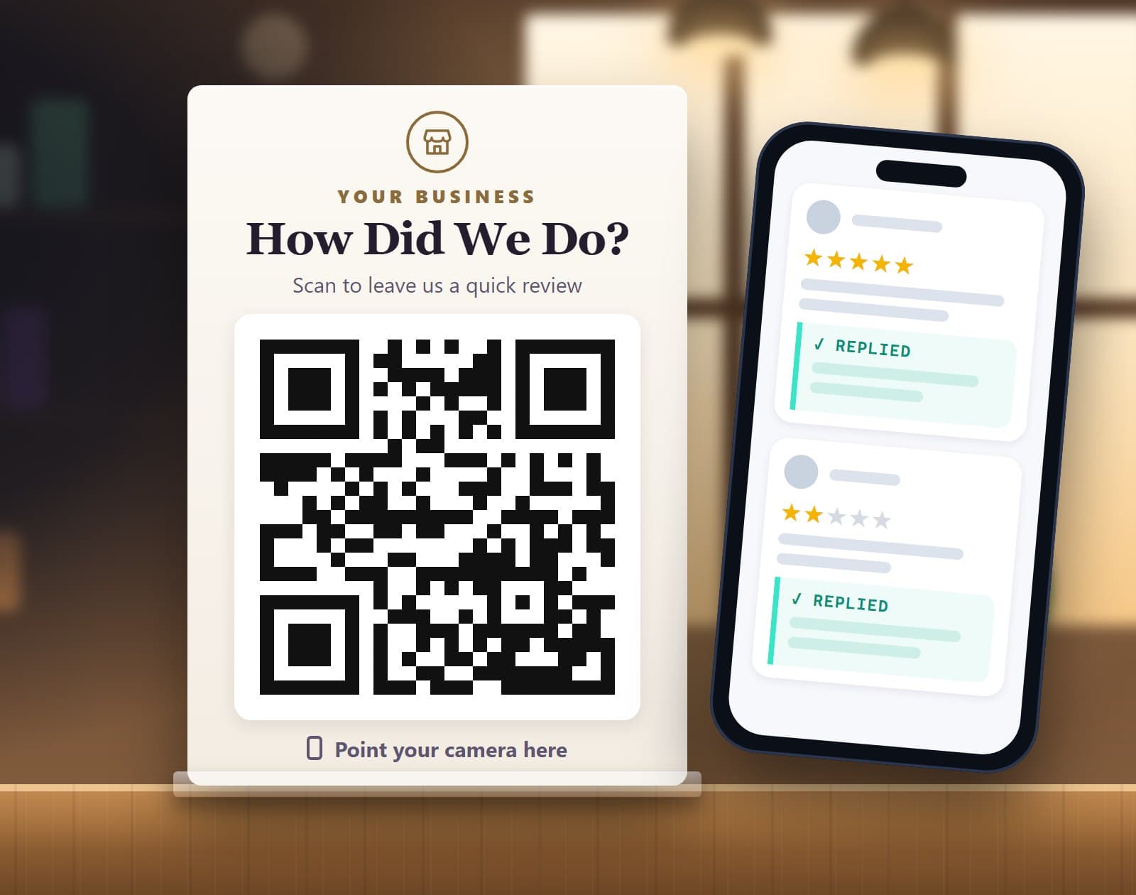 A sample review card reading How Did We Do?, with a QR code, standing on a shop counter next to a phone showing Google reviews marked replied.